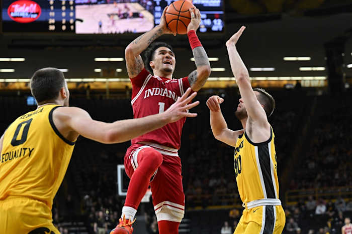 Indiana Hoosiers guard Jalen Hood-Schifino (1) goes to the basket as Iowa Hawkeyes guard Connor McCaffery (30) and forward Filip Rebraca (0) defend during the first half at Carver-Hawkeye Arena.